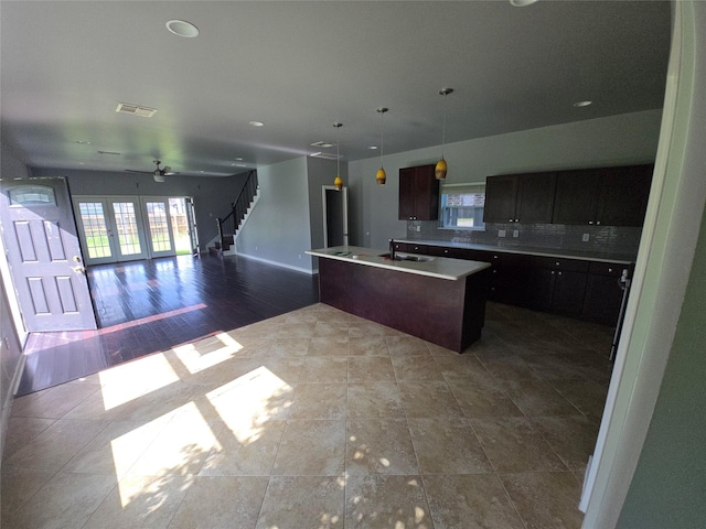 146 Disney St, Arcola, TX 77583 - kitchen with plenty of natural light, french doors, a kitchen island with sink, open floor plan, and recessed lighting