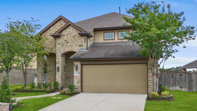 16746 Highland Country Dr, Cypress, TX 77433 - french country home with stone siding, driveway, and a shingled roof