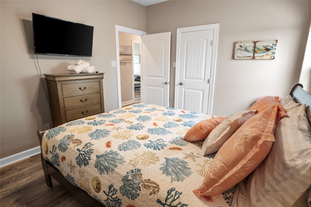 975 S S Cv, Crystal Beach, TX 77650 - bedroom featuring dark wood-style flooring and baseboards