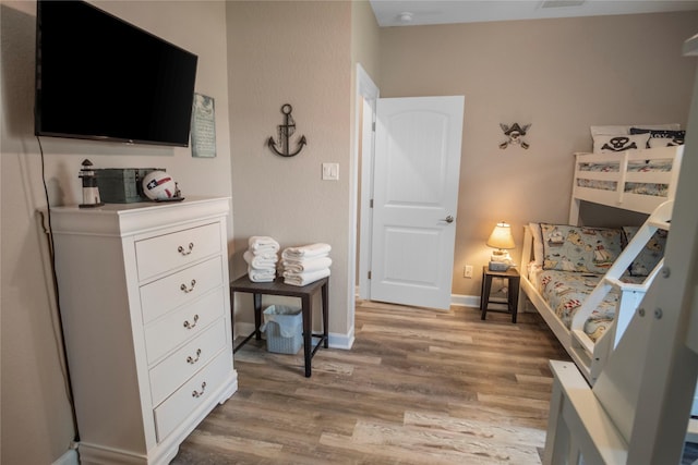 975 S S Cv, Crystal Beach, TX 77650 - bedroom with light wood-style flooring and baseboards
