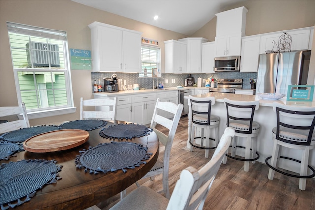 975 S S Cv, Crystal Beach, TX 77650 - kitchen featuring stainless steel appliances, light countertops, decorative backsplash, and lofted ceiling