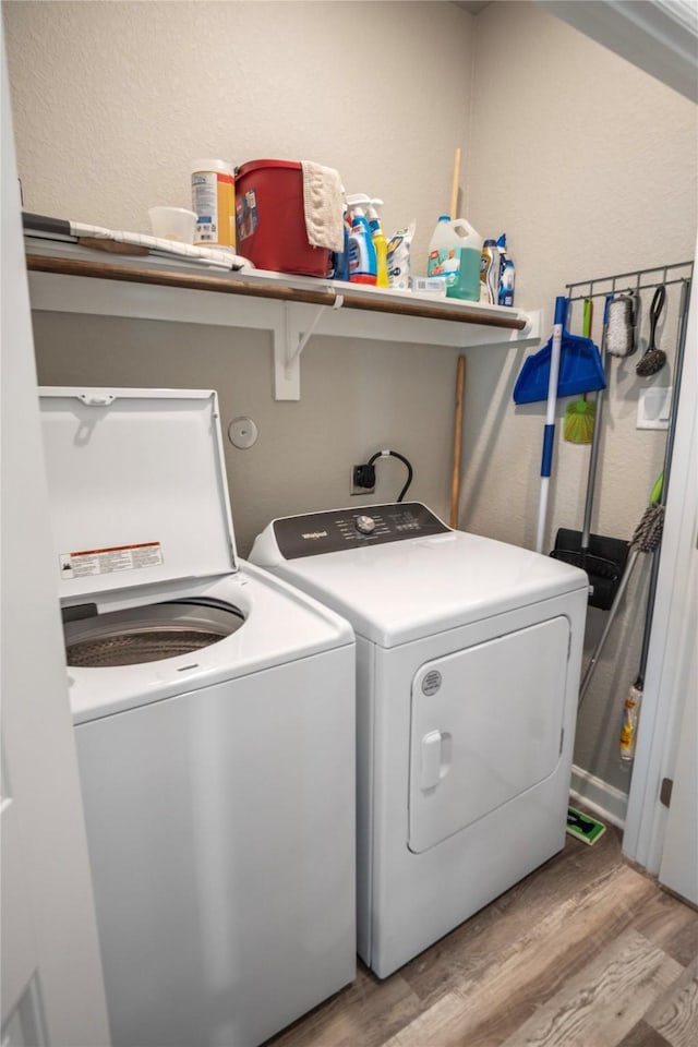 975 S S Cv, Crystal Beach, TX 77650 - laundry area featuring washer and dryer and light wood-style flooring