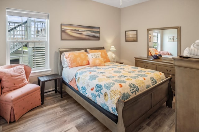 975 S S Cv, Crystal Beach, TX 77650 - bedroom with wood finished floors and multiple windows