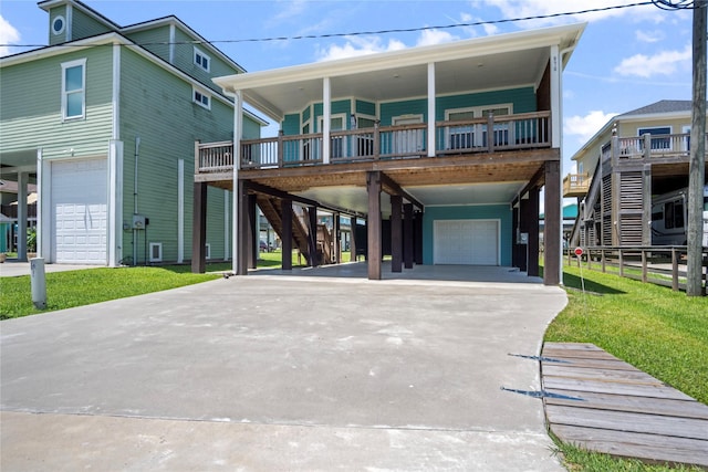 975 S S Cv, Crystal Beach, TX 77650 - raised beach house featuring an attached garage, a carport, stairs, concrete driveway, and a front lawn