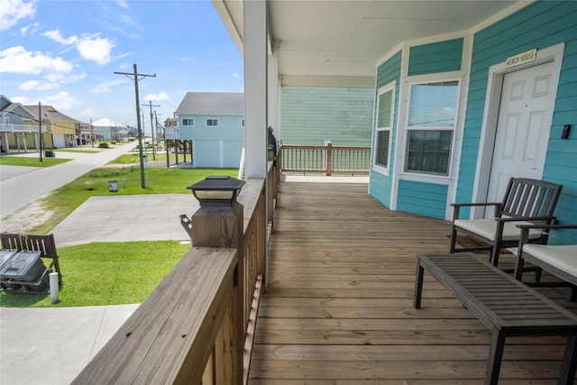 975 S S Cv, Crystal Beach, TX 77650 - wooden porch featuring a residential view and a yard