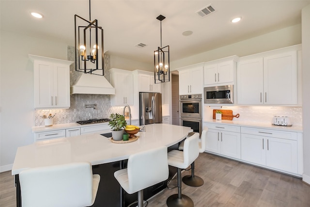 19506 Bradford Pines Ct, Cypress, TX 77433 - kitchen featuring stainless steel appliances, backsplash, light wood finished floors, light countertops, and recessed lighting