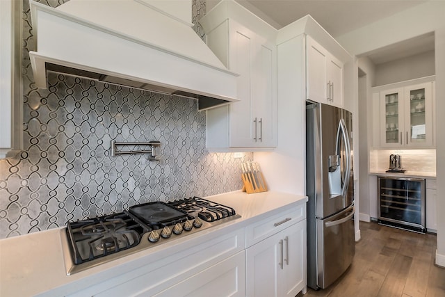 19506 Bradford Pines Ct, Cypress, TX 77433 - kitchen featuring stainless steel appliances, wine cooler, custom exhaust hood, light countertops, and wood-type flooring