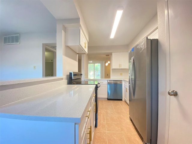 2601 S Braeswood Blvd Unit 605, Houston, TX 77025 - kitchen featuring appliances with stainless steel finishes, white cabinets, light tile patterned floors, and light stone countertops