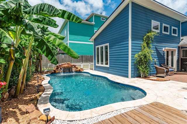 1017 Forest Rd, Clear Lake Shores, TX 77565 - view of swimming pool featuring french doors, a fenced backyard, and a wooden deck