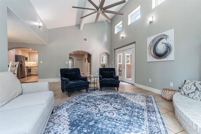 1017 Forest Rd, Clear Lake Shores, TX 77565 - living room with ceiling fan, a high ceiling, light tile patterned floors, plenty of natural light, and beam ceiling