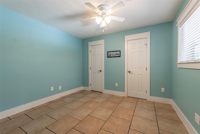1017 Forest Rd, Clear Lake Shores, TX 77565 - unfurnished bedroom with light tile patterned floors, ceiling fan, and a closet