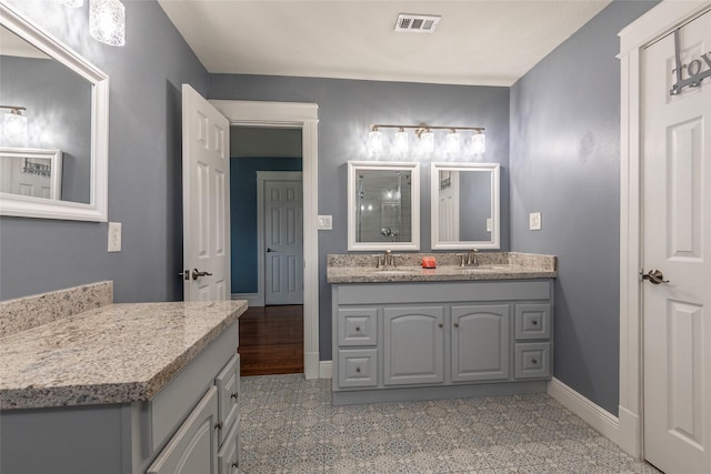 1017 Forest Rd, Clear Lake Shores, TX 77565 - full bathroom with double vanity and baseboards