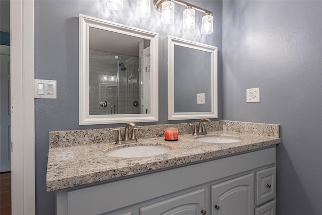1017 Forest Rd, Clear Lake Shores, TX 77565 - bathroom featuring double vanity and a shower with shower door
