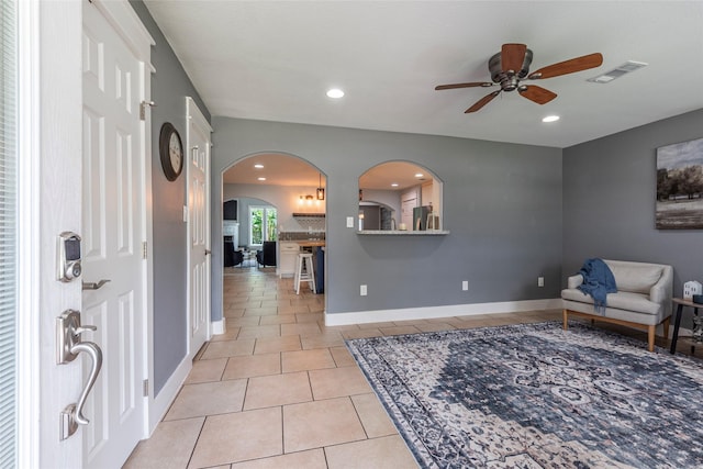 1017 Forest Rd, Clear Lake Shores, TX 77565 - entrance foyer featuring ceiling fan, arched walkways, light tile patterned flooring, and recessed lighting