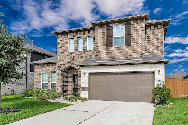 8619 Flamingo Bay Ln, Cypress, TX 77433 - french country inspired facade with a garage, driveway, and brick siding