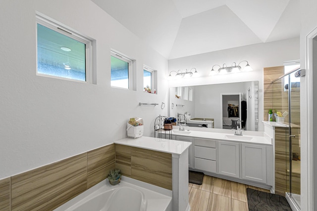 8619 Flamingo Bay Ln, Cypress, TX 77433 - bathroom featuring a shower stall, vanity, a garden tub, and lofted ceiling