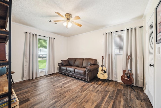 3214 Churchill St, Pearland, TX 77581 - living room with dark wood-type flooring, a ceiling fan, ornamental molding, and a textured ceiling