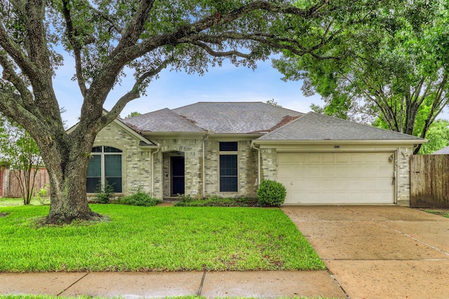 7215 Pembrough Ln, Katy, TX 77494 - view of front of home featuring a garage, driveway, roof with shingles, and brick siding