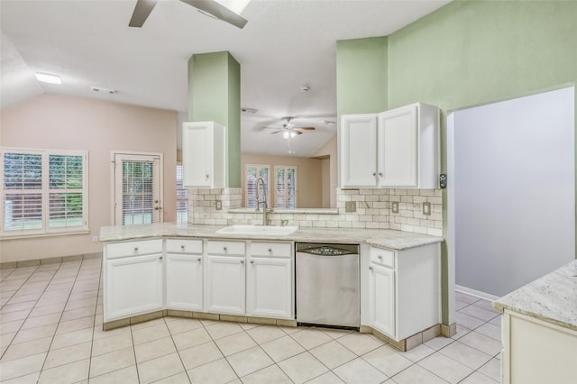 7215 Pembrough Ln, Katy, TX 77494 - kitchen with dishwasher, ceiling fan, lofted ceiling, decorative backsplash, and white cabinetry