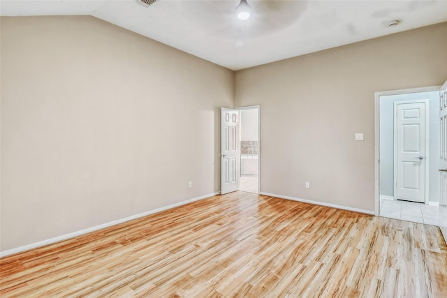7215 Pembrough Ln, Katy, TX 77494 - empty room with light wood finished floors, a ceiling fan, and vaulted ceiling