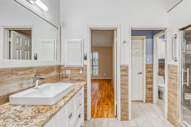 7215 Pembrough Ln, Katy, TX 77494 - bathroom with vanity, tile walls, tile patterned flooring, a wainscoted wall, and a shower