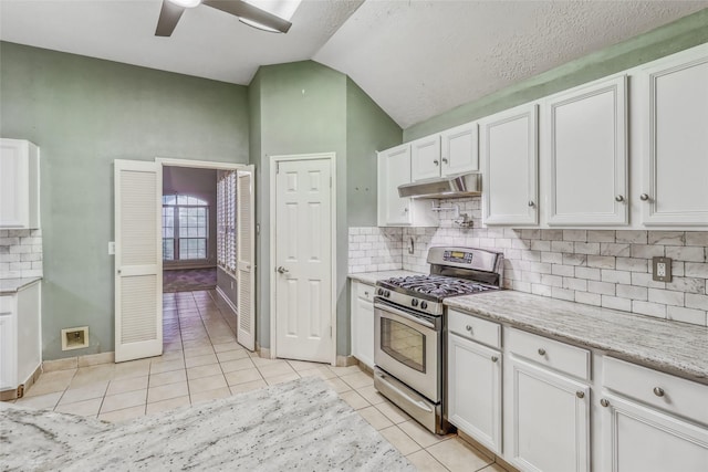 7215 Pembrough Ln, Katy, TX 77494 - kitchen featuring stainless steel range with gas stovetop, white cabinetry, light tile patterned floors, a ceiling fan, and under cabinet range hood
