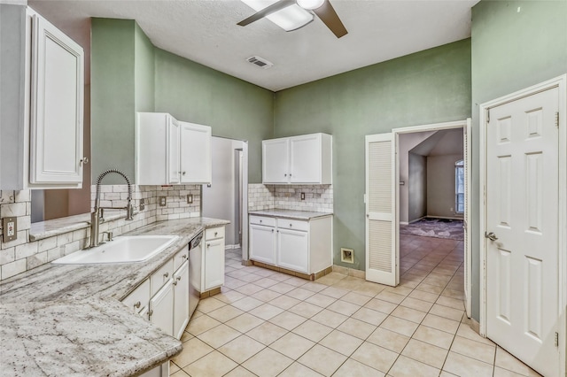 7215 Pembrough Ln, Katy, TX 77494 - kitchen featuring a ceiling fan, backsplash, white cabinets, light tile patterned floors, and dishwasher