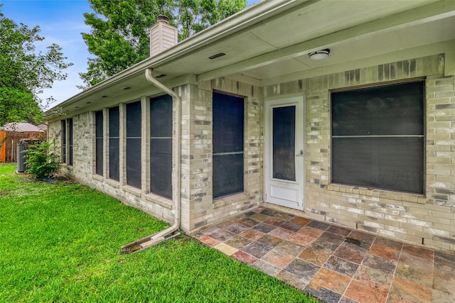 7215 Pembrough Ln, Katy, TX 77494 - doorway to property with a yard, a chimney, a patio, and brick siding