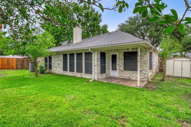 7215 Pembrough Ln, Katy, TX 77494 - back of house featuring a storage unit, a chimney, roof with shingles, a patio area, and brick siding