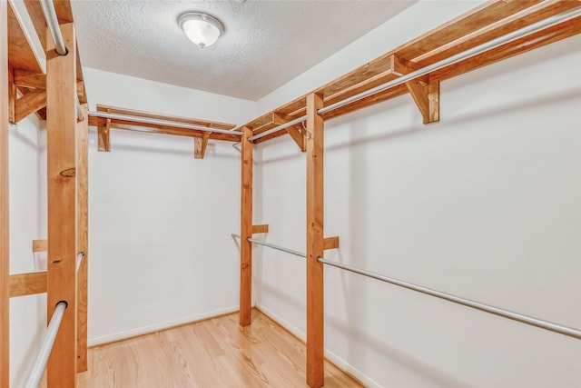 7215 Pembrough Ln, Katy, TX 77494 - walk in closet featuring wood finished floors