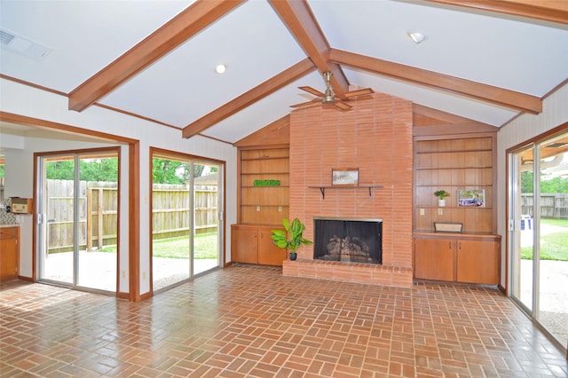 823 Timber Cove Dr, Seabrook, TX 77586 - unfurnished living room with a brick fireplace, built in shelves, ceiling fan, and plenty of natural light