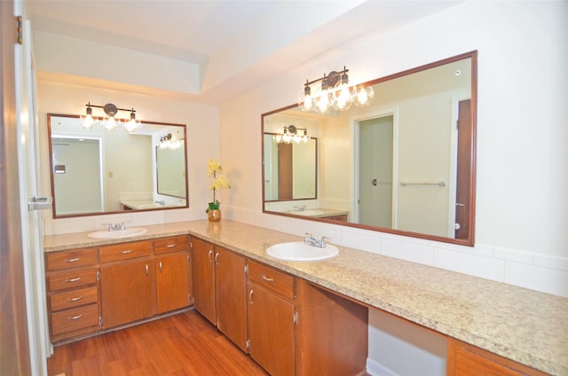 823 Timber Cove Dr, Seabrook, TX 77586 - bathroom featuring a chandelier, double vanity, and wood finished floors