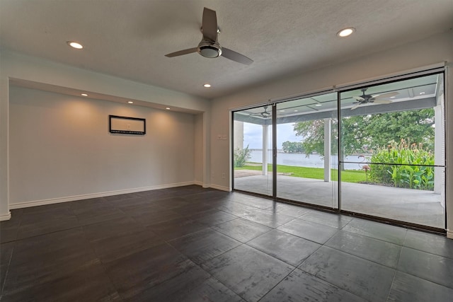 1437 Bowsprit Pt, Willis, TX 77318 - empty room featuring ceiling fan, recessed lighting, and a water view
