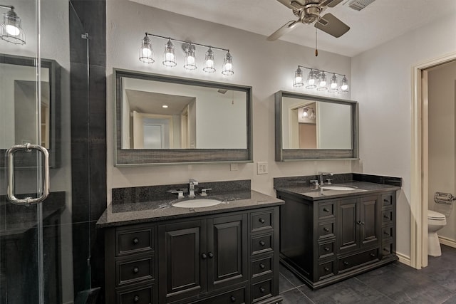 1437 Bowsprit Pt, Willis, TX 77318 - full bathroom with two vanities, a ceiling fan, and a shower stall