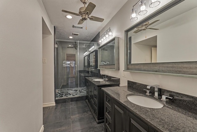 1437 Bowsprit Pt, Willis, TX 77318 - bathroom featuring a ceiling fan, a stall shower, two vanities, tile patterned floors, and a textured ceiling