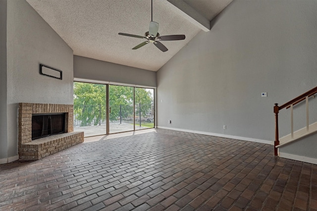 1437 Bowsprit Pt, Willis, TX 77318 - unfurnished living room featuring ceiling fan, high vaulted ceiling, brick floors, a fireplace, and a textured ceiling