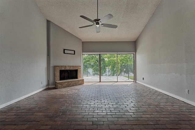 1437 Bowsprit Pt, Willis, TX 77318 - unfurnished living room featuring a textured ceiling, a ceiling fan, a textured wall, brick floors, and a brick fireplace