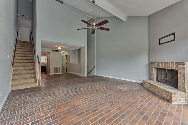 1437 Bowsprit Pt, Willis, TX 77318 - unfurnished living room featuring brick flooring, a ceiling fan, stairway, a brick fireplace, and beam ceiling