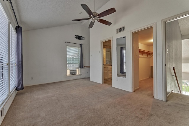 1437 Bowsprit Pt, Willis, TX 77318 - unfurnished bedroom featuring carpet, a walk in closet, multiple windows, cooling unit, and a textured ceiling