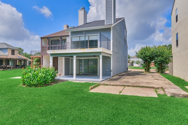 1437 Bowsprit Pt, Willis, TX 77318 - rear view of property with a chimney, a patio area, a balcony, a lawn, and a shingled roof