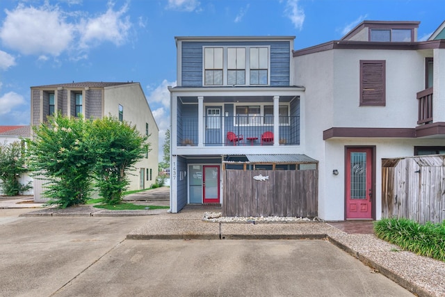 1437 Bowsprit Pt, Willis, TX 77318 - view of front of home featuring a balcony and stucco siding