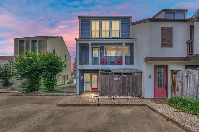 1437 Bowsprit Pt, Willis, TX 77318 - view of front facade featuring a balcony and stucco siding