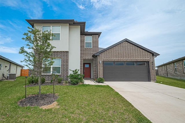 3943 Austins Pass, Katy, TX 77494 - view of front of home featuring brick siding, a garage, driveway, a front yard, and stucco siding