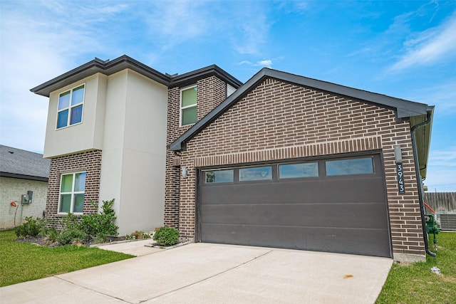 3943 Austins Pass, Katy, TX 77494 - modern home featuring brick siding, driveway, an attached garage, and stucco siding