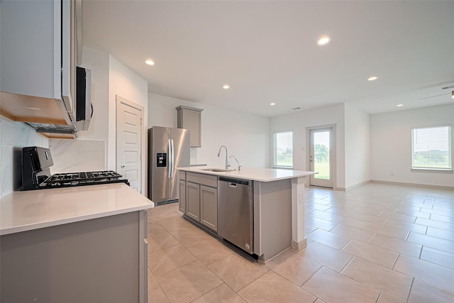 3943 Austins Pass, Katy, TX 77494 - kitchen with stainless steel appliances, gray cabinets, healthy amount of natural light, open floor plan, and recessed lighting