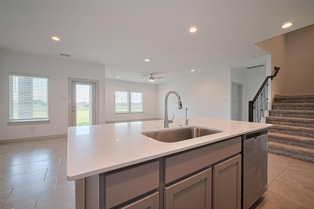 3943 Austins Pass, Katy, TX 77494 - kitchen featuring stainless steel dishwasher, gray cabinets, open floor plan, light tile patterned floors, and light countertops