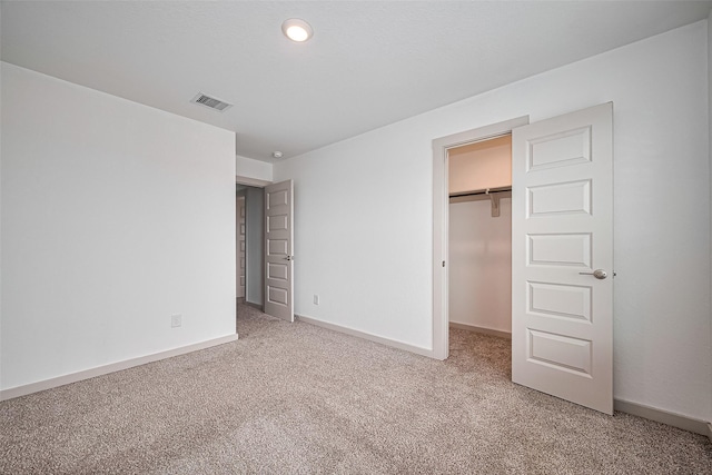 3943 Austins Pass, Katy, TX 77494 - unfurnished bedroom featuring carpet, a walk in closet, and a closet