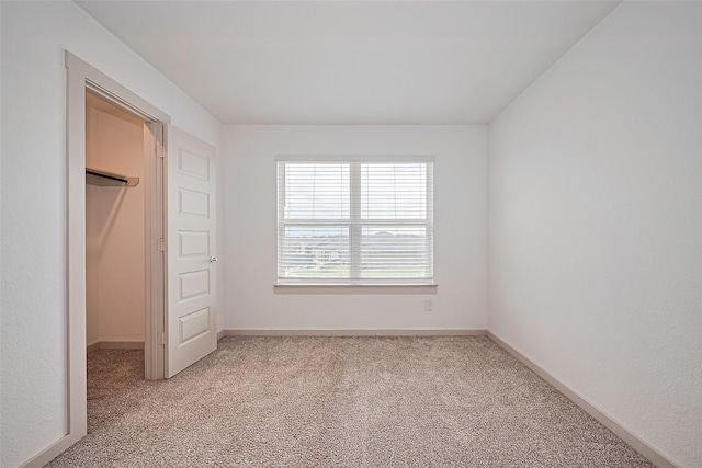 3943 Austins Pass, Katy, TX 77494 - unfurnished bedroom with a walk in closet, light carpet, and a closet