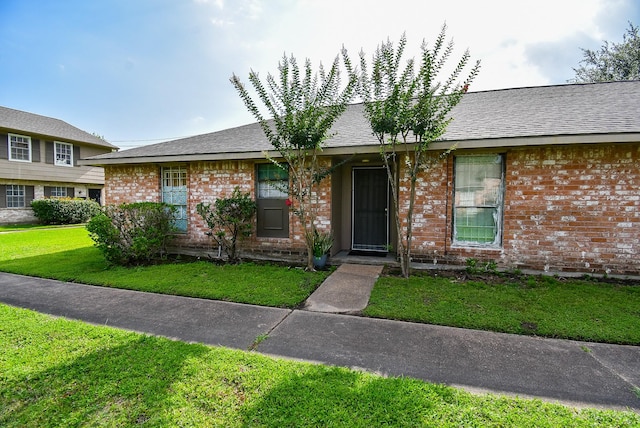 12469 Sharpview Dr Unit 2469, Houston, TX 77072 - view of front of home with brick siding, a front yard, and a shingled roof