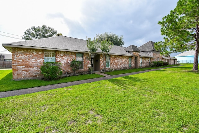 12469 Sharpview Dr Unit 2469, Houston, TX 77072 - view of front of home featuring brick siding, a front yard, and roof with shingles